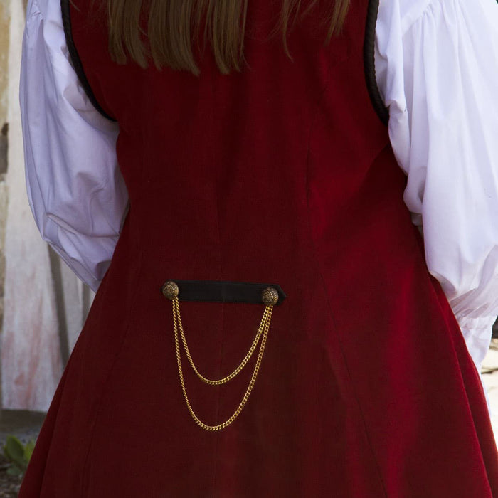 red corduroy sleeveless coat with pleated duck-tail, faux black leather collar and shoulder accents, gold buttons and trim